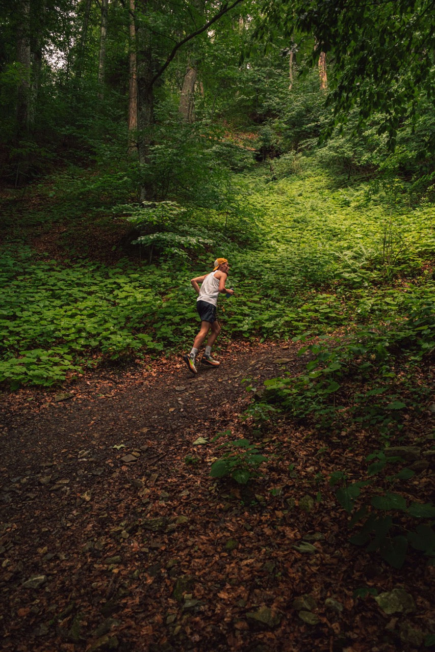 woman running on wooded trail