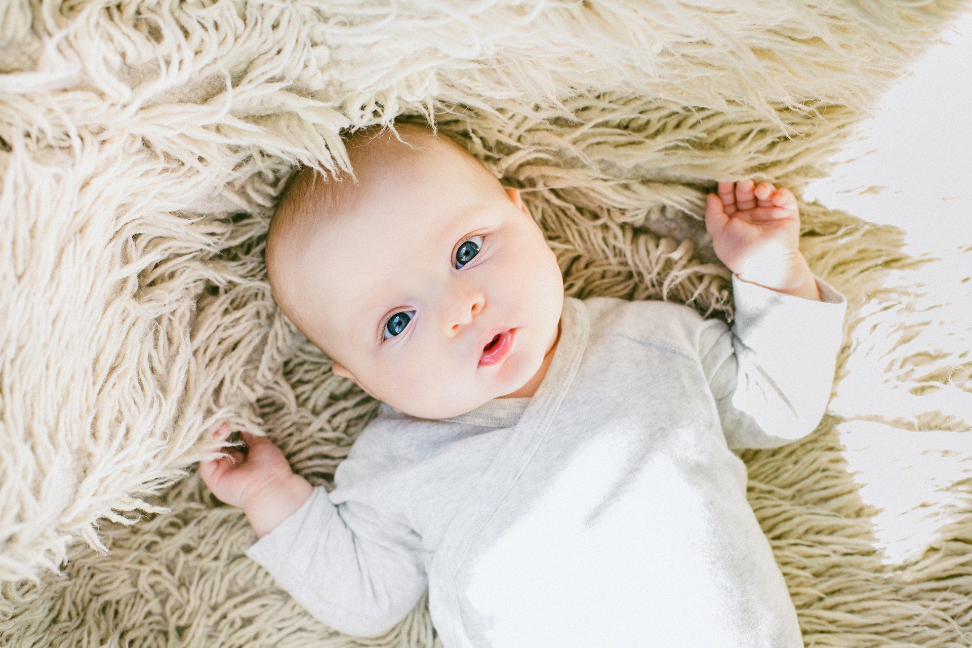 baby laying on blanket