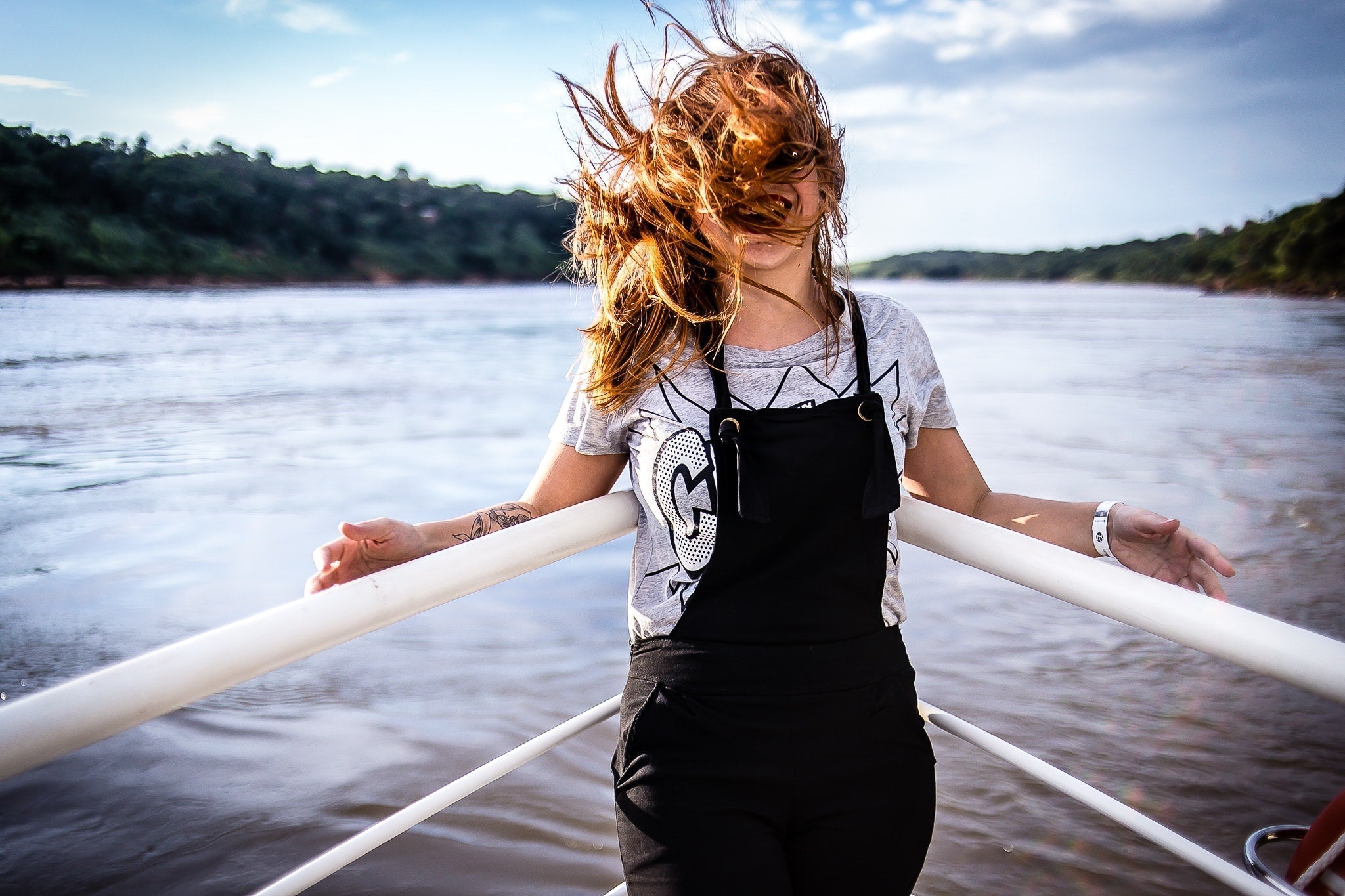 woman on boat on water with hair flying