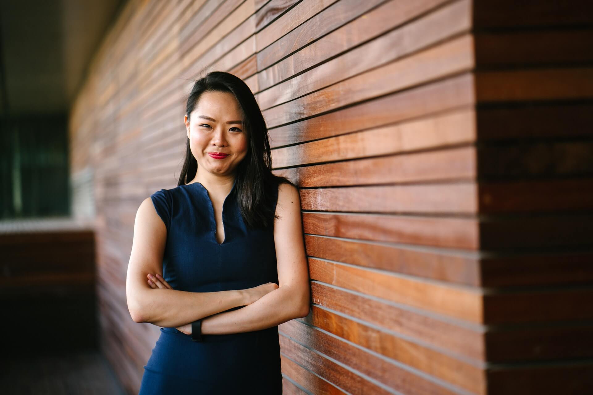 woman smiling leaning against a wall