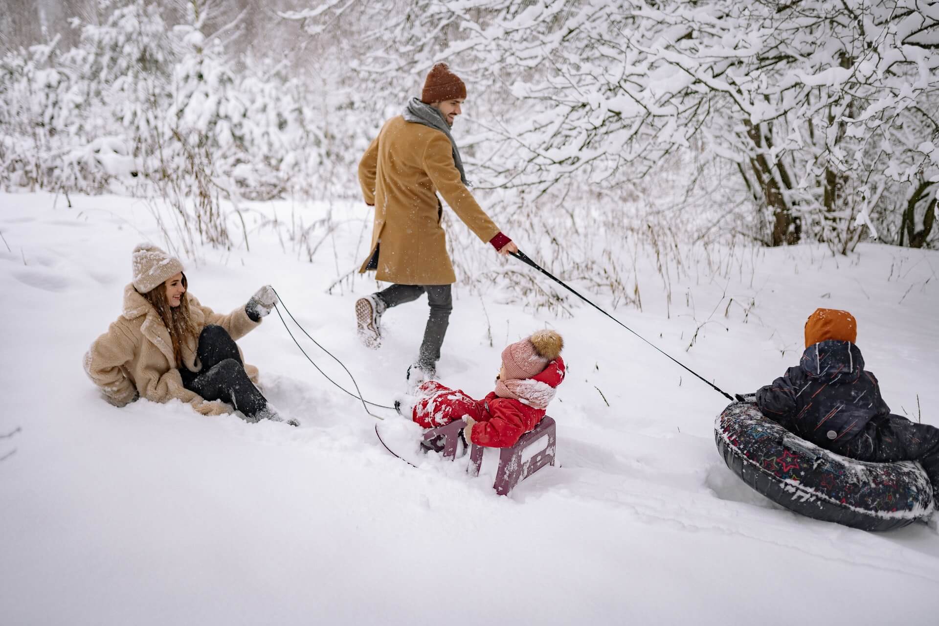 family sledding in the snow