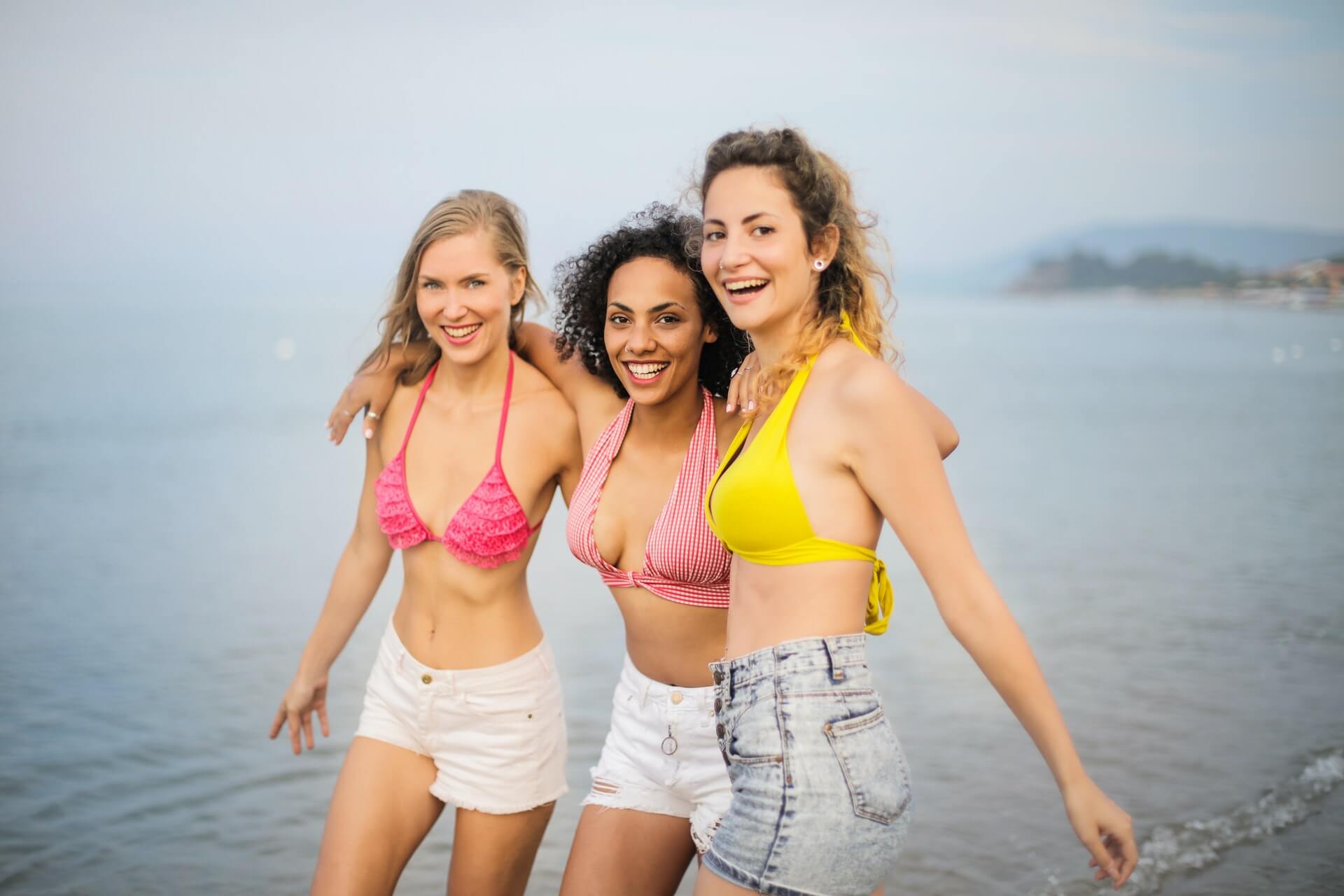 women dancing in ocean surf