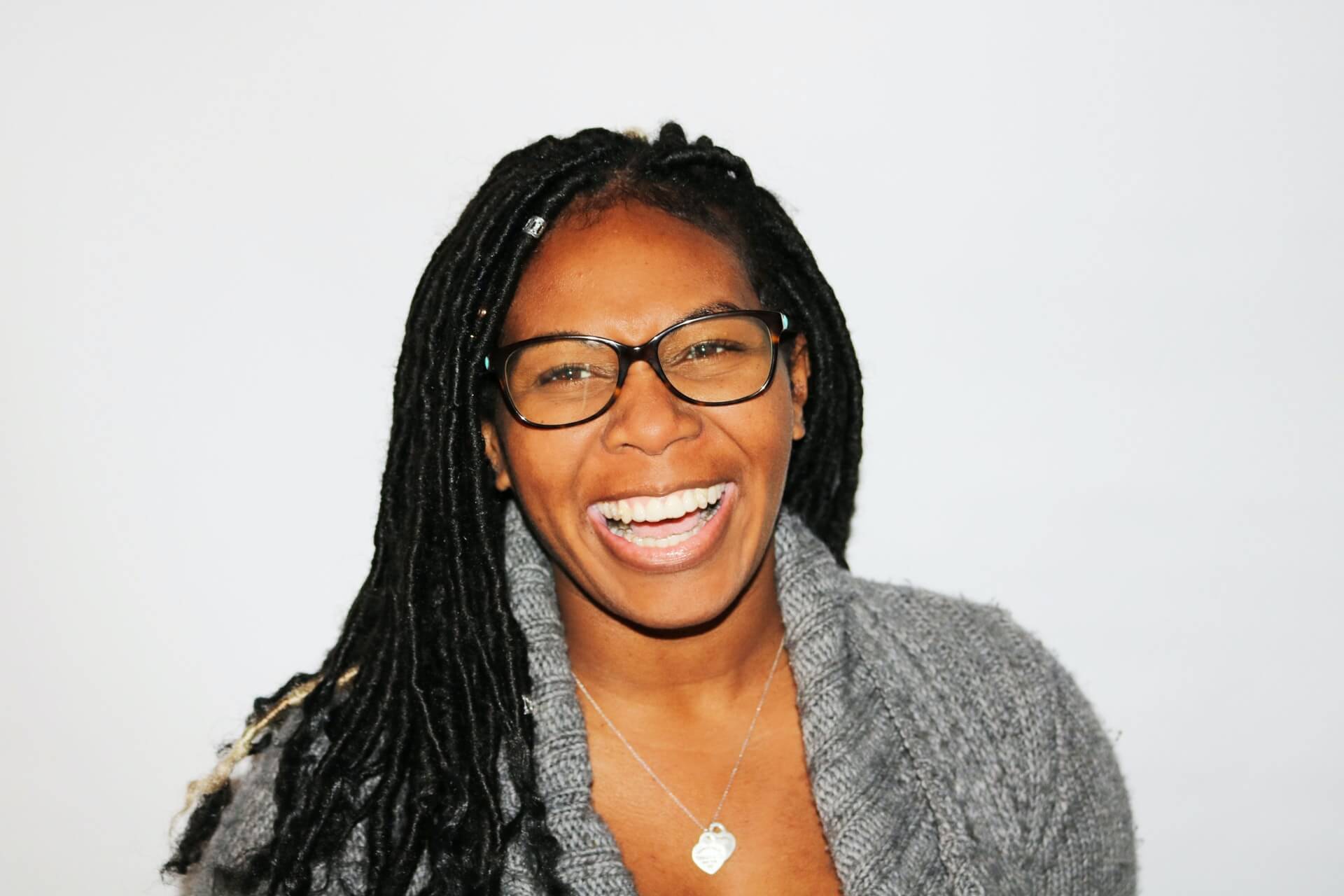 woman in sweater laughing