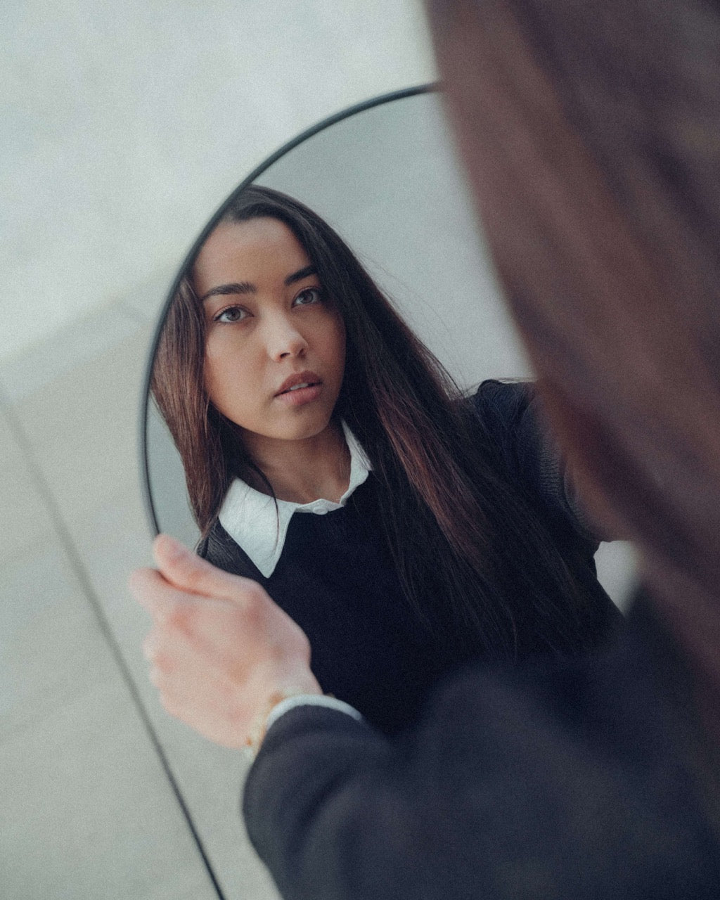 woman looking in mirror