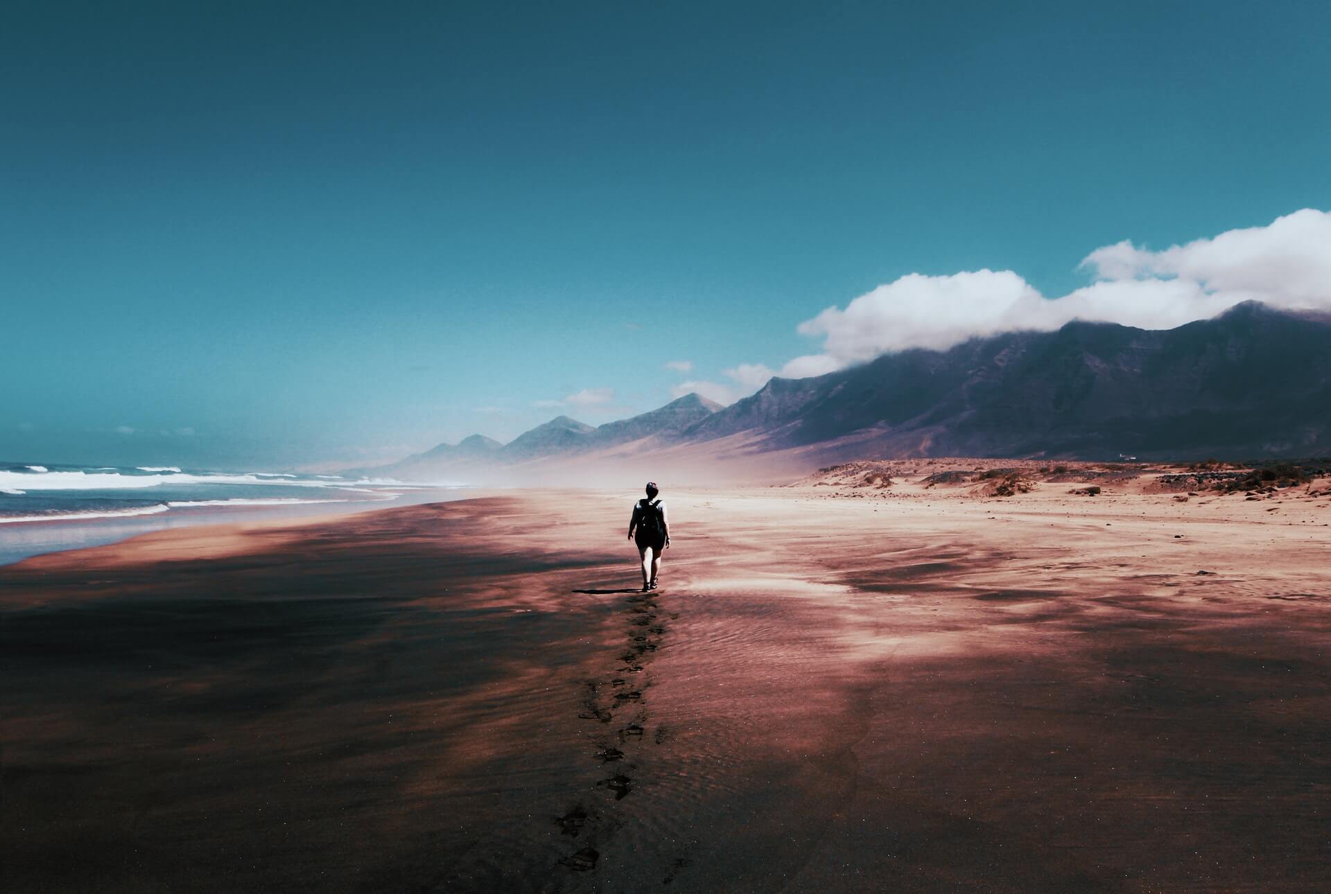 person walking on beach