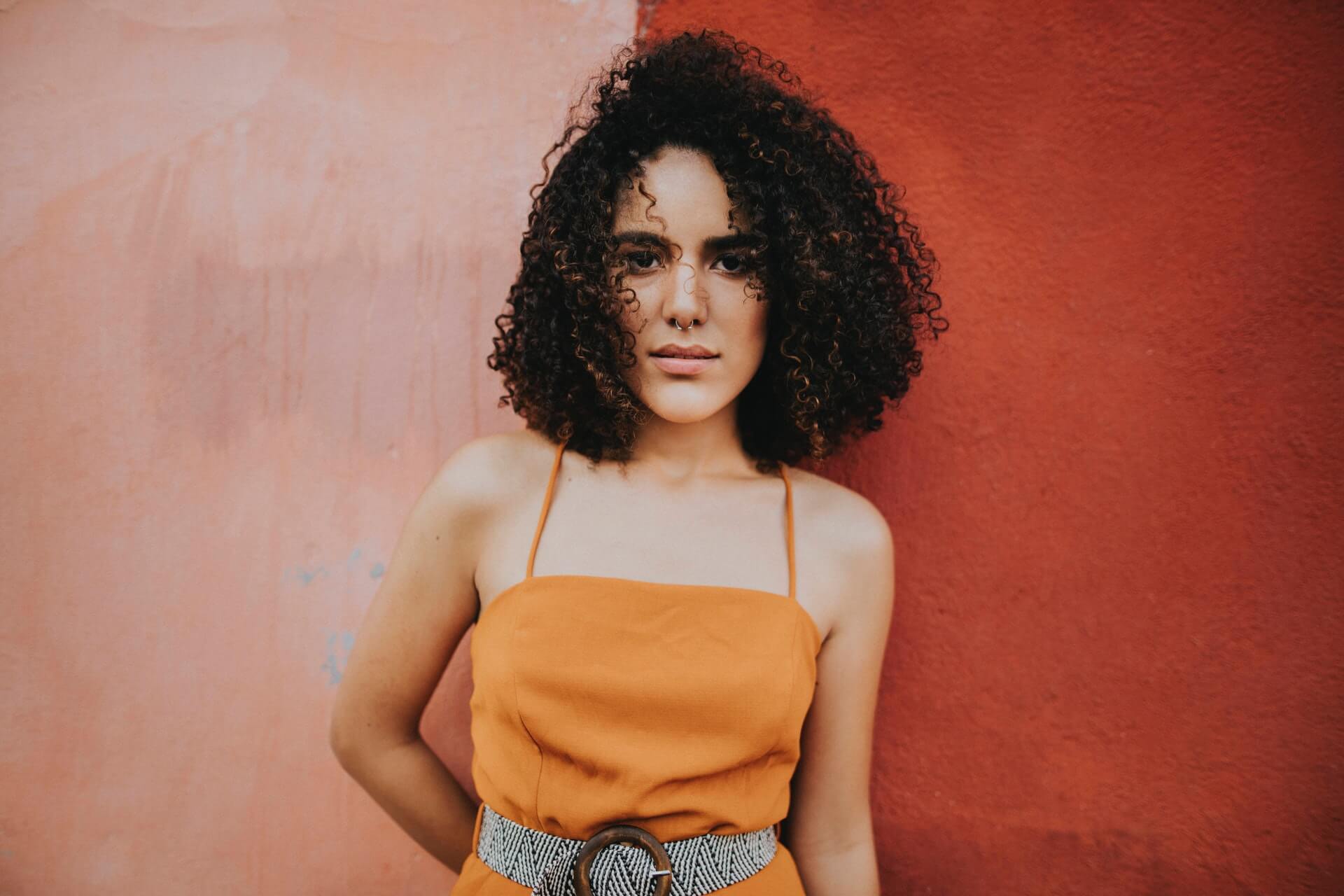 woman by red wall