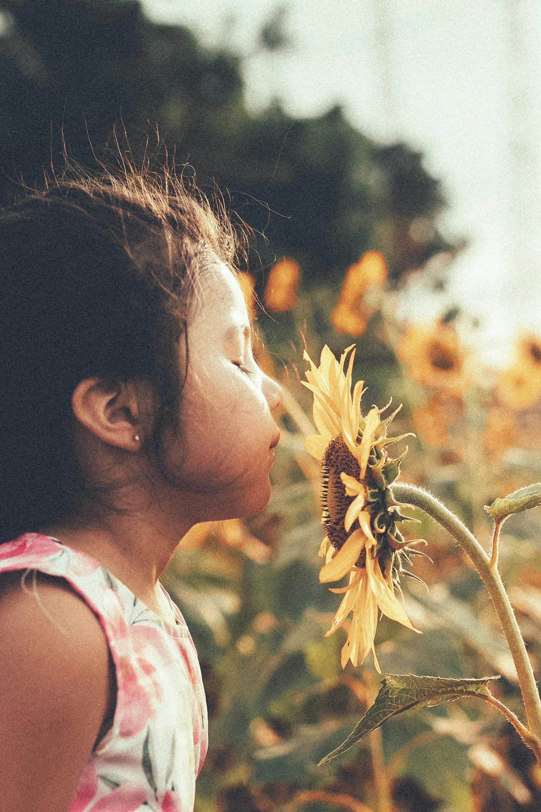 girl smelling flower