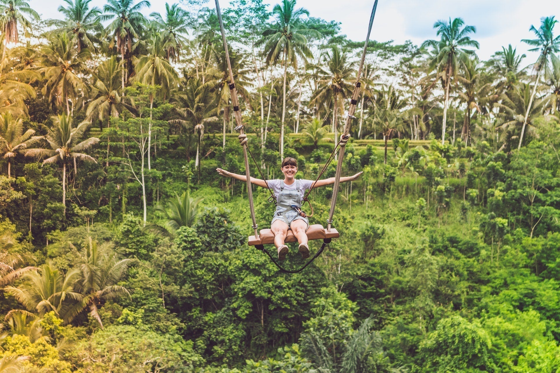 woman on swing in the jungle