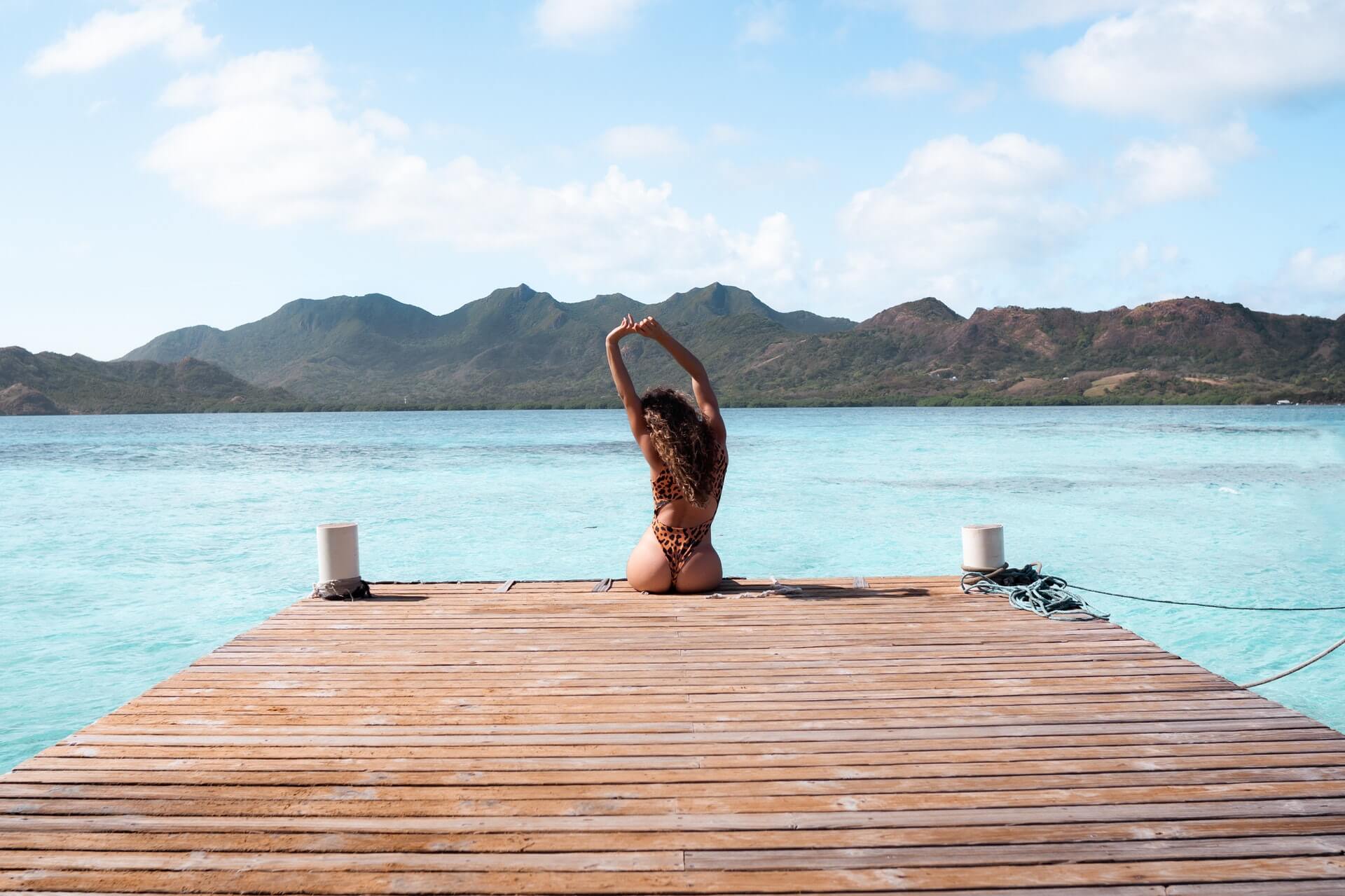 woman stretching on dock by water