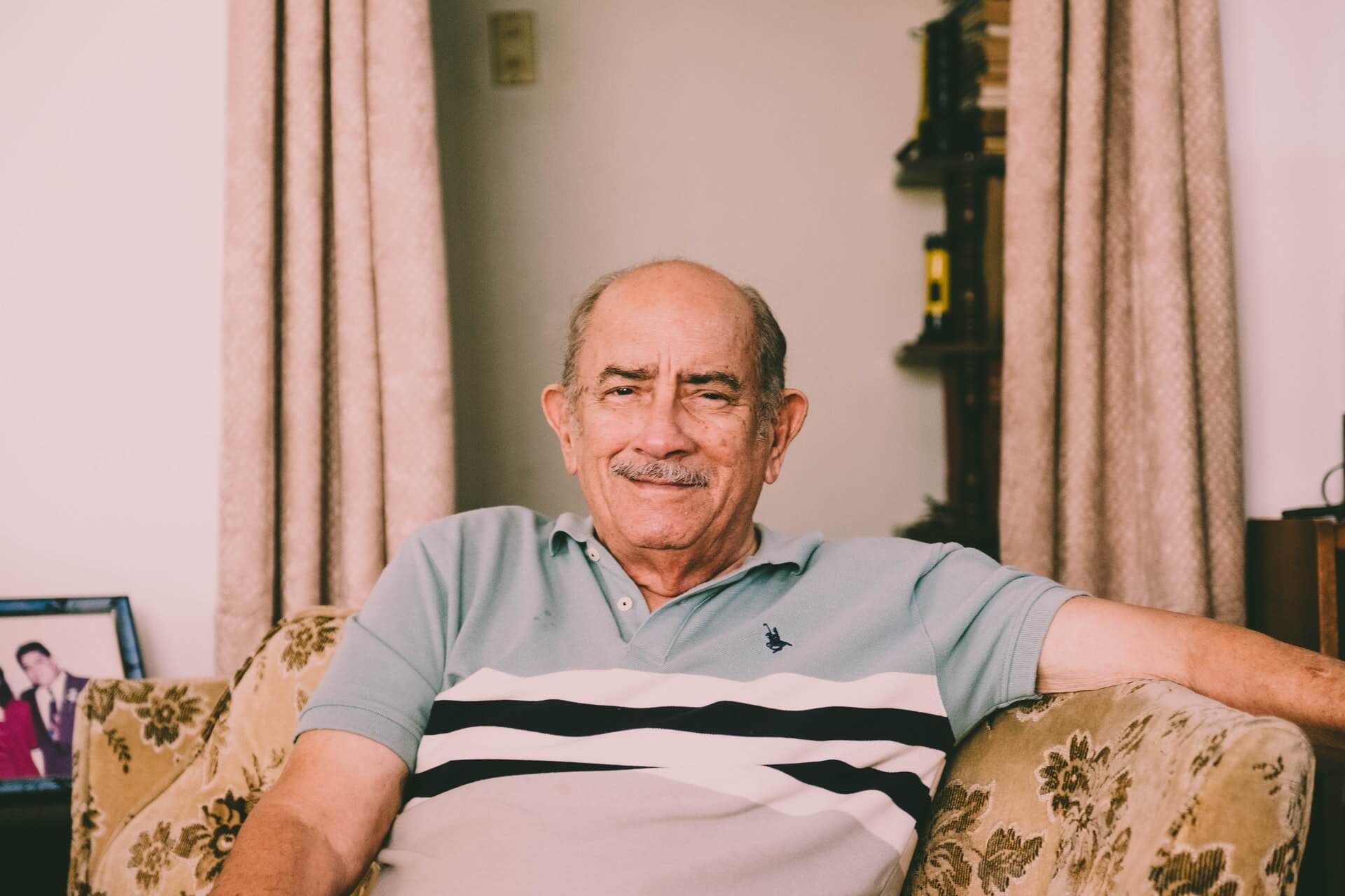 older man sitting on couch