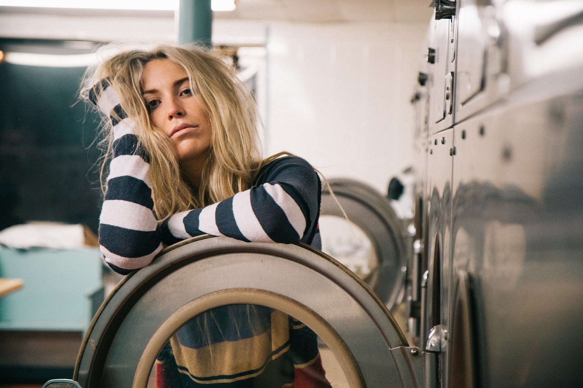 girl in striped shirt in the laundry room