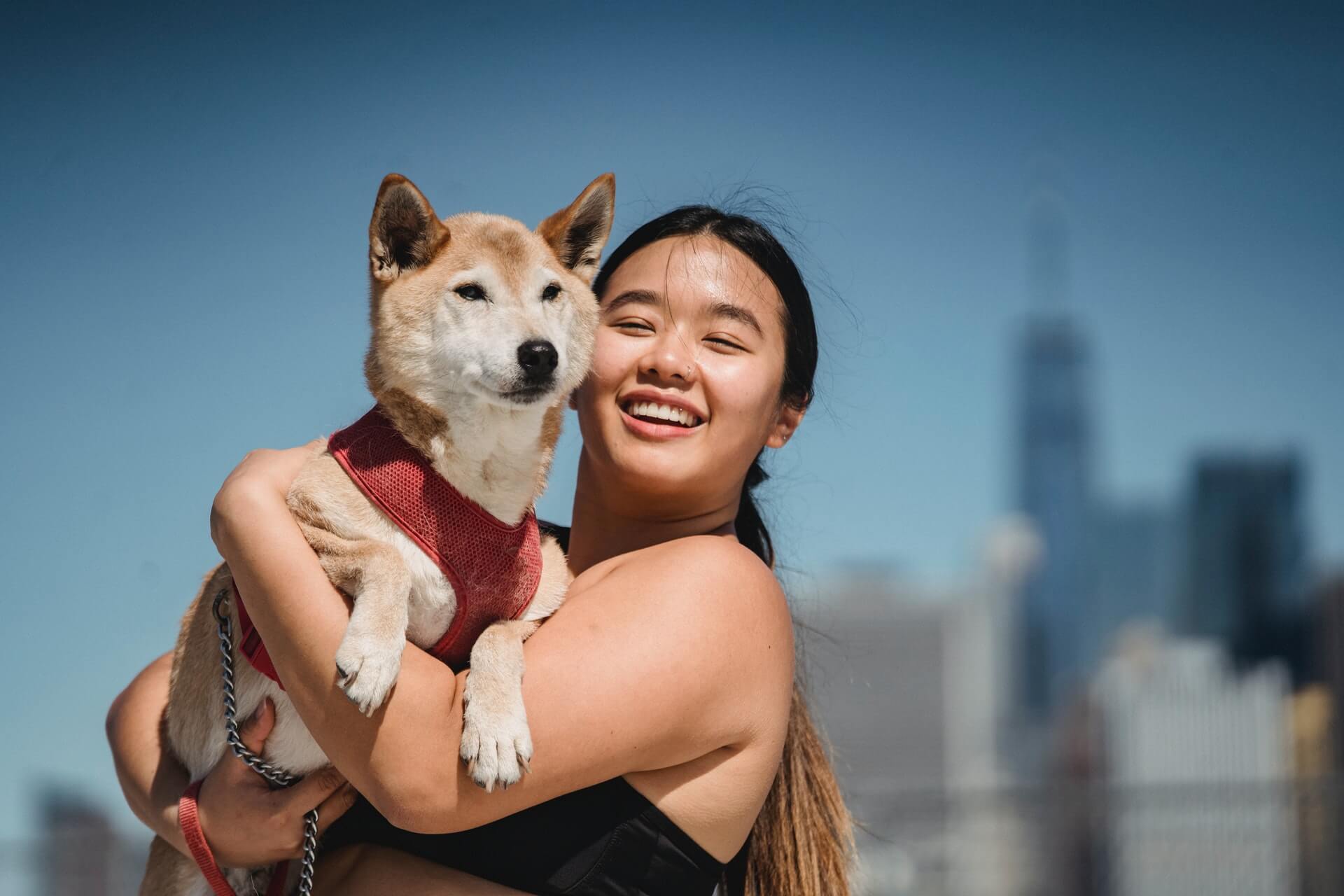 woman holding dog smiling