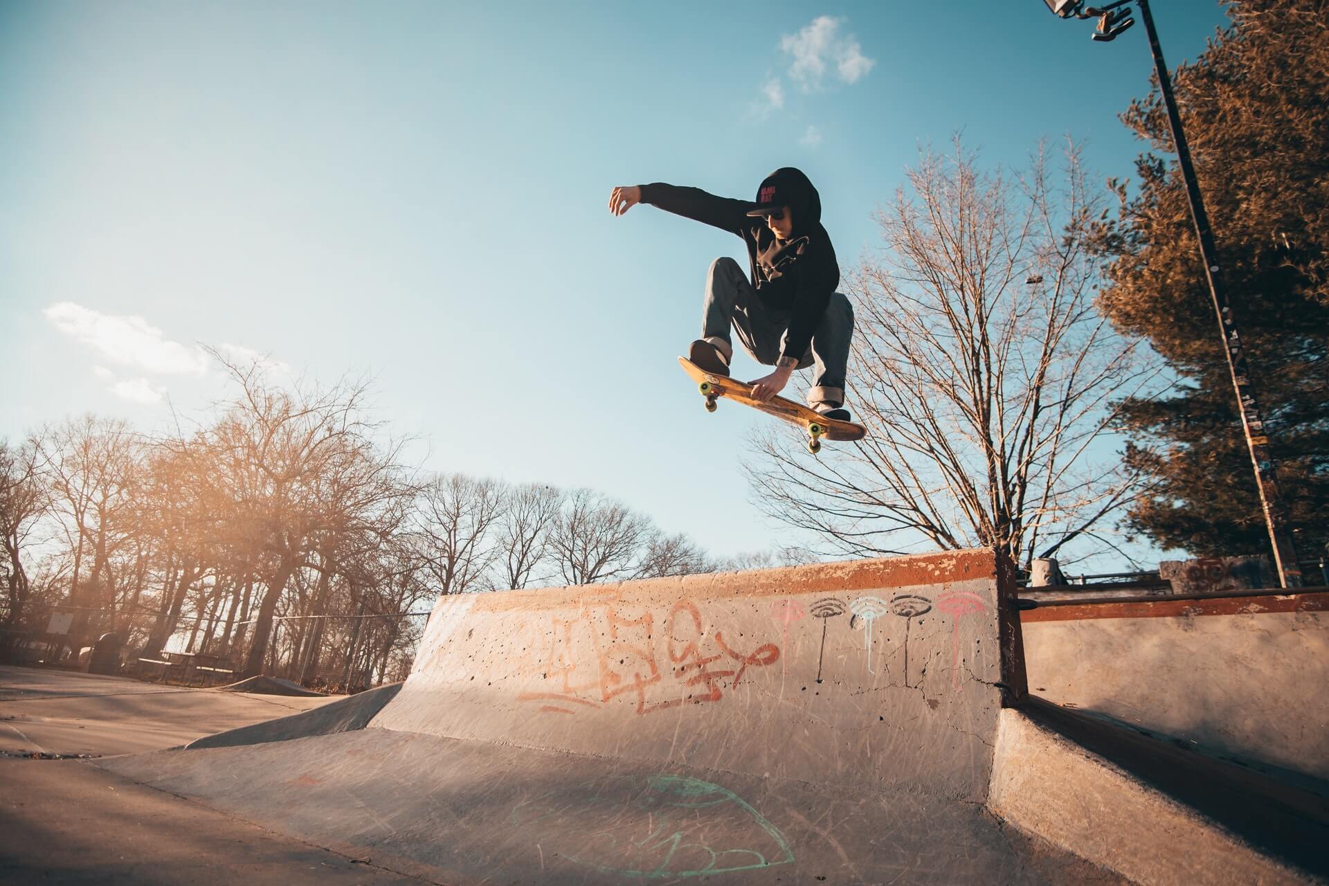 skateboarder catching air at skatepark