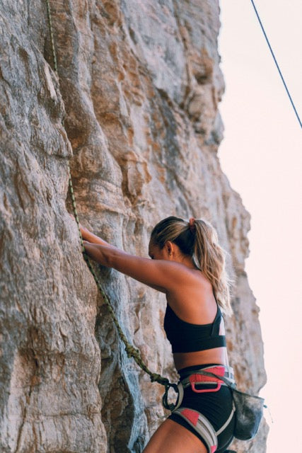 woman rock climbing
